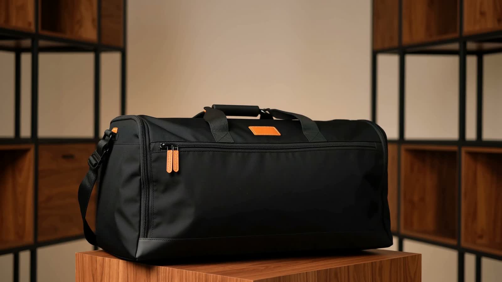 Black Long's Sacks weekender bag on a warm wood pedestal