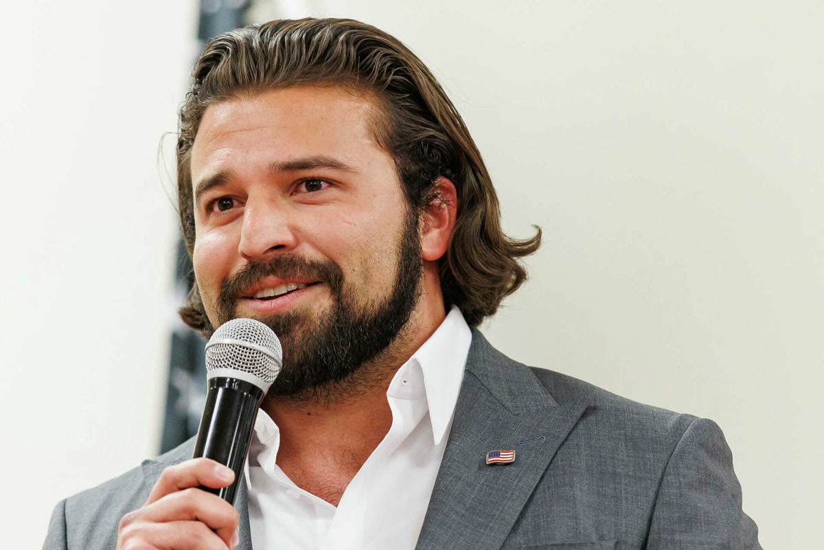 Brandon holding a microphone, showing his face at a slight angle